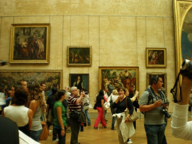 Throngs of tourists at the Hall of Italian Masters at the Louvre. The same hall houses the Louvre's most popular resident, the Mona Lisa.