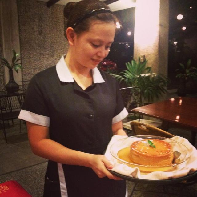 A member of the staff serving leche flan for one of the groups I brought for merienda cena. 